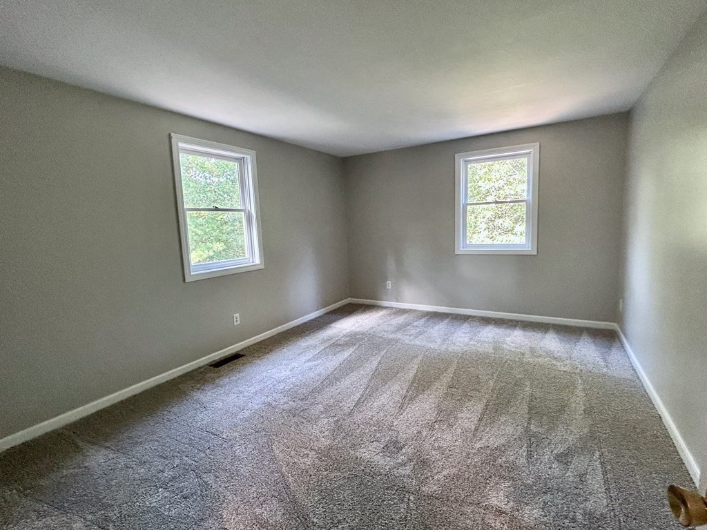 275 Burroughs Road Boxborough, MA 01719 - Photo 21 of 23 an empty room with a window