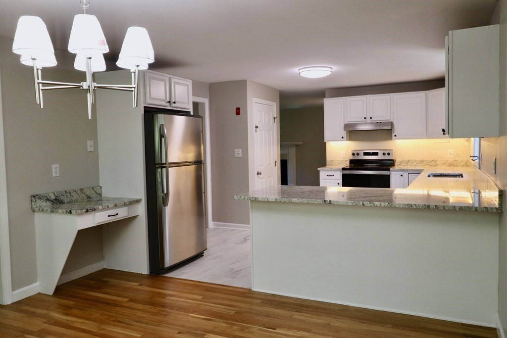 275 Burroughs Road Boxborough, MA 01719 - Photo 4 of 23 a kitchen with stainless steel appliances granite countertop a refrigerator and a sink