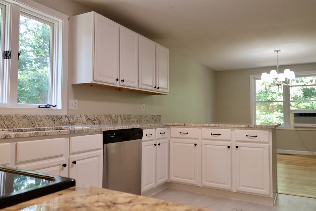275 Burroughs Road Boxborough, MA 01719 - Photo 6 of 23 a kitchen with granite countertop white cabinets and window