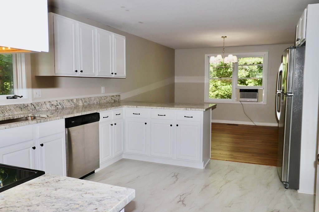 275 Burroughs Road Boxborough, MA 01719 - Photo 7 of 23 a kitchen with granite countertop white cabinets and window