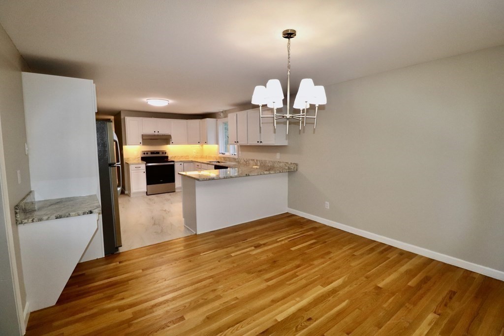 275 Burroughs Road Boxborough, MA 01719 - Photo 8 of 23 a view of a kitchen with a sink wooden cabinets and stainless steel appliances