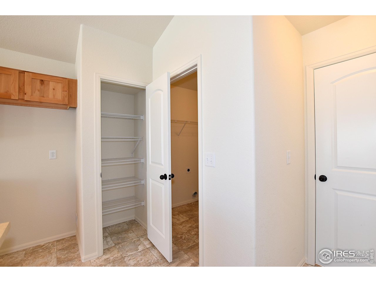 915 Milner Pass Road Severance, CO 80550 - Photo 19 of 37 a view of a hallway with wooden floor