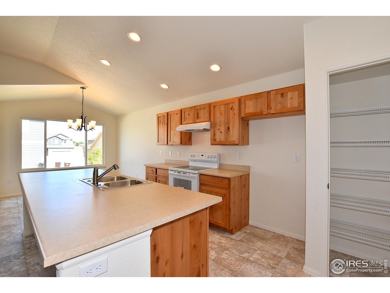 915 Milner Pass Road Severance, CO 80550 - Photo 20 of 37 a kitchen with stainless steel appliances a sink a stove a refrigerator and cabinets