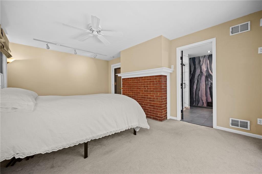 371 Highland Road Pittsburgh, PA 15235 - Photo 10 of 50 a bed room with a bed and a ceiling fan