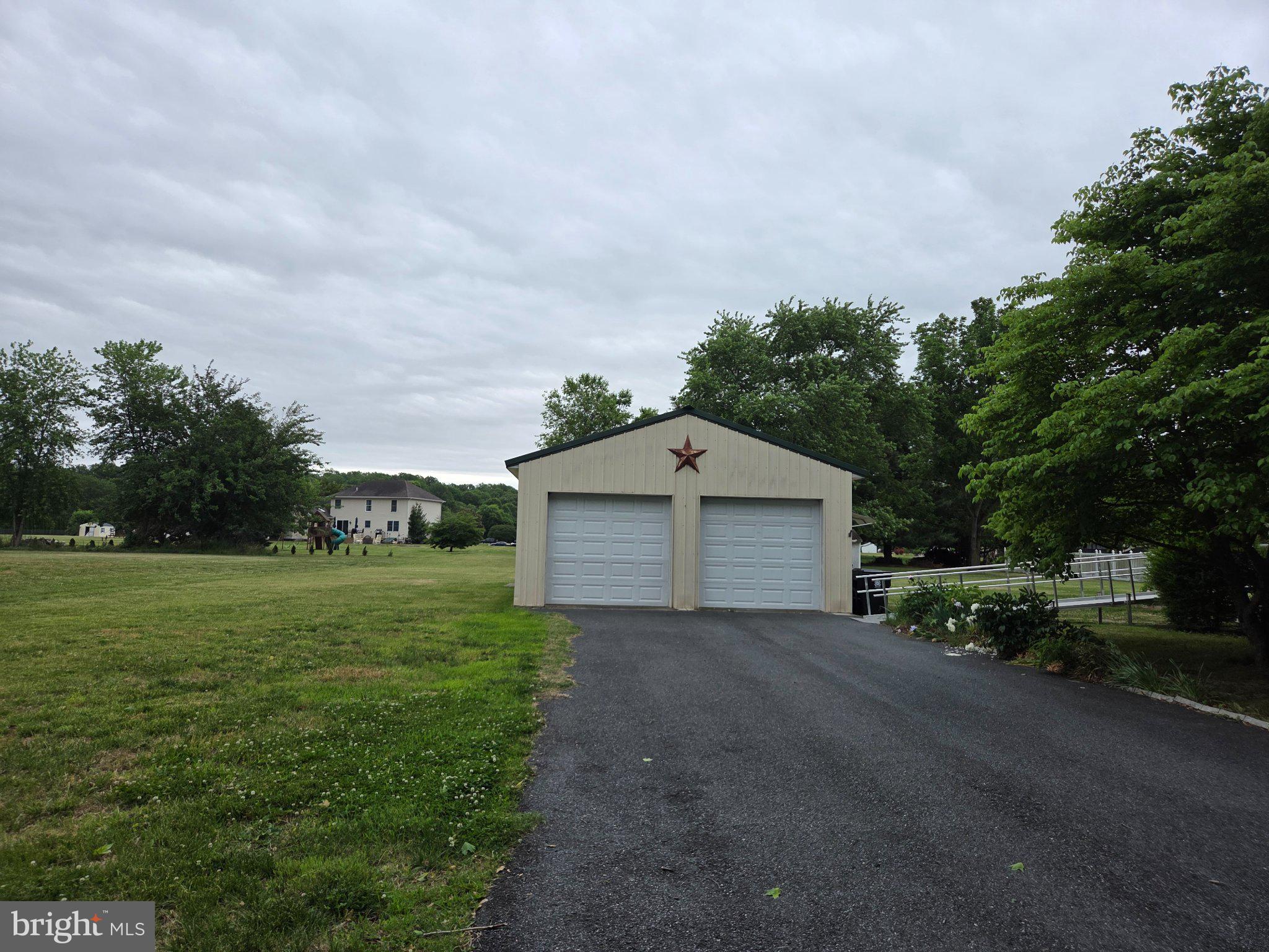 1378 Woodlytown Road Magnolia, DE 19962 - Photo 2 of 15 a view of a house with a yard and large trees