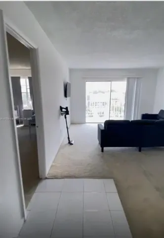 a living room with a couch and a window