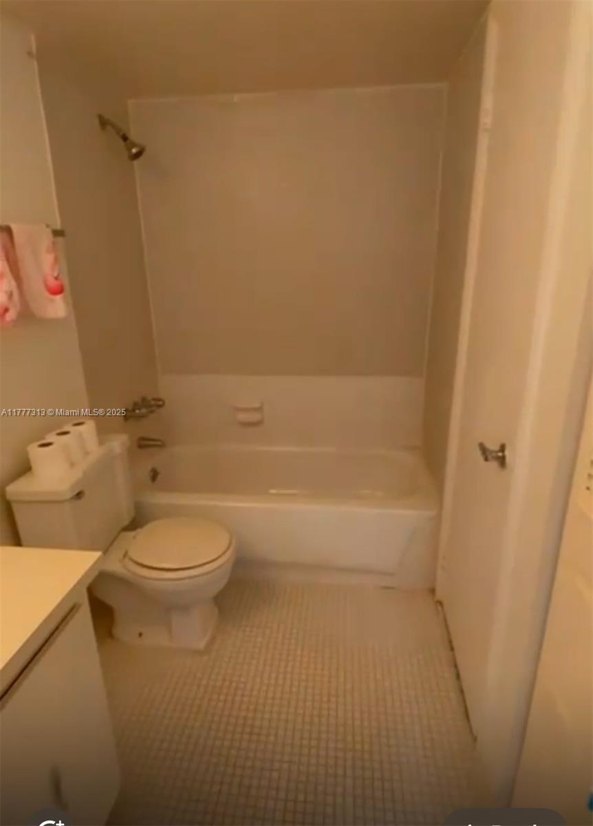 496 Northwest 165th Street, Unit D611 Miami, FL 33169 - Photo 6 of 7 a bathroom with a toilet and a shower