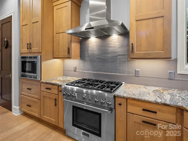 a kitchen with granite countertop a stove and a sink