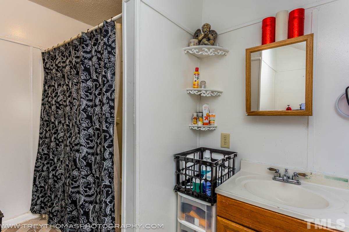 1126 Boyer Street Raleigh, NC 27610 - Photo 6 of 9 a bathroom with a sink and a mirror
