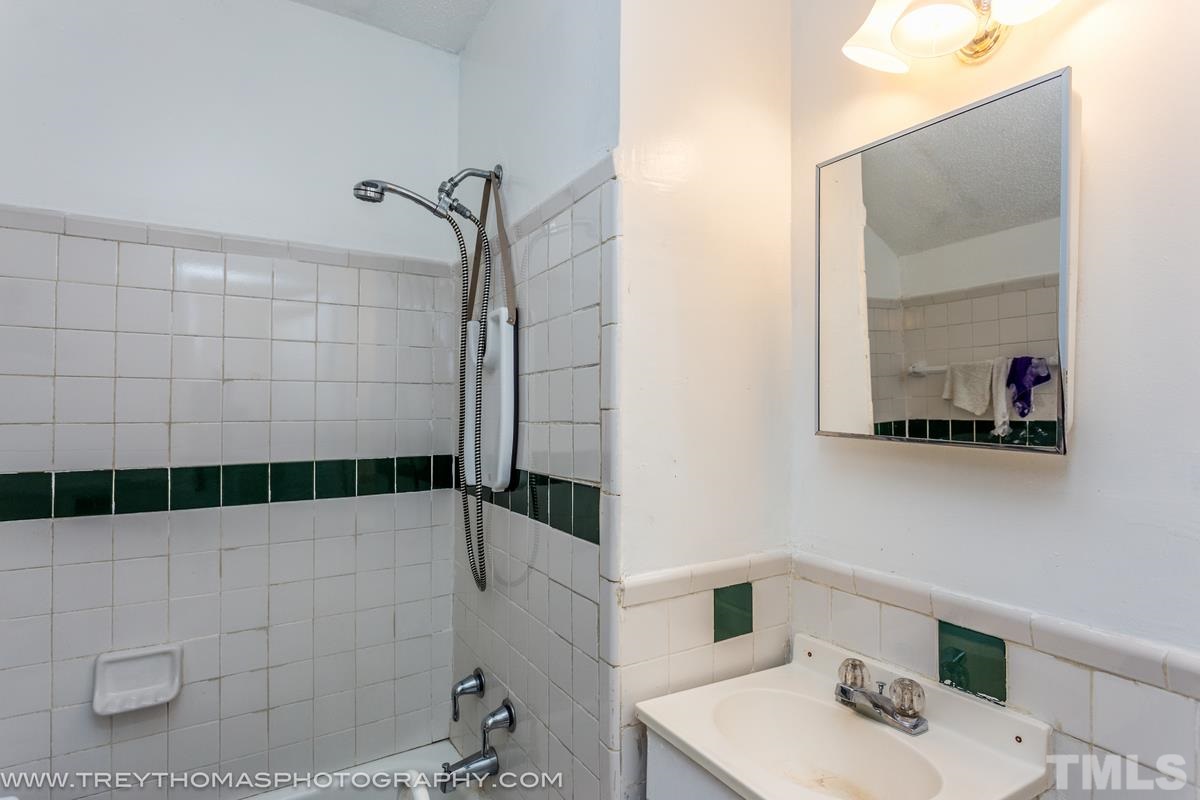 1126 Boyer Street Raleigh, NC 27610 - Photo 7 of 9 a bathroom with a sink and a mirror