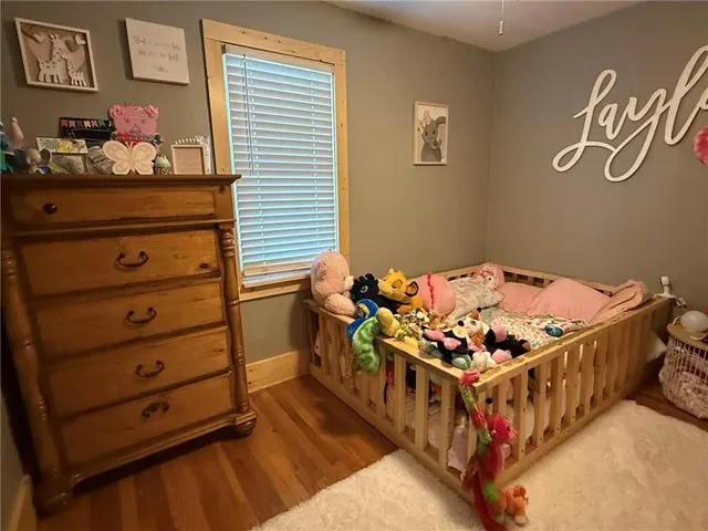 a bedroom with a bed and cabinet