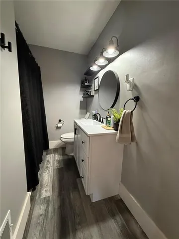 a room with wooden floor and white walls