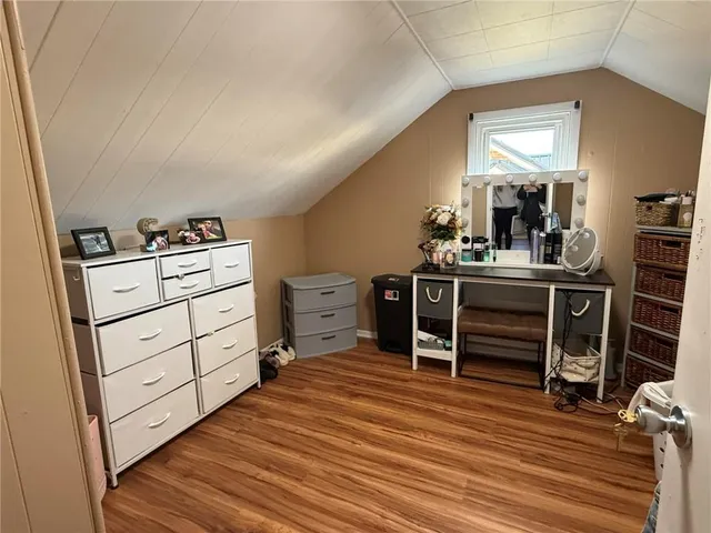 a room with furniture a air conditioner vent and a window