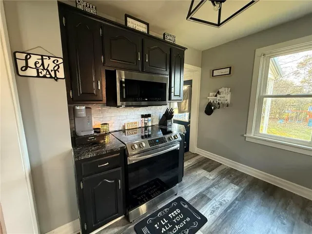 a kitchen with stainless steel appliances granite countertop a stove and a refrigerator
