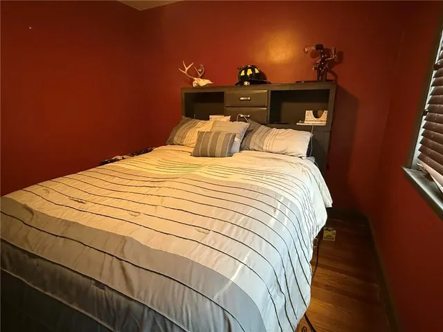 a bed sitting in a bedroom next to a lamp