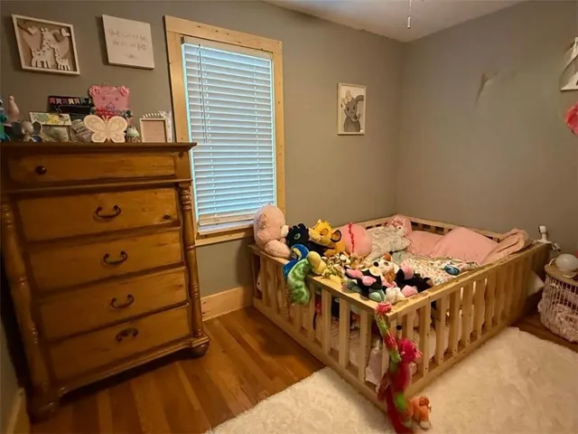 a bedroom with a bed and a dresser