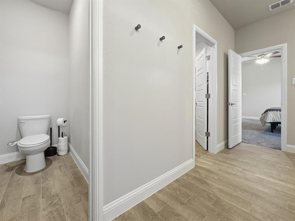 2216 Redwing Drive Denton, TX 76205 - Photo 22 of 38 a bathroom with a toilet and a shower
