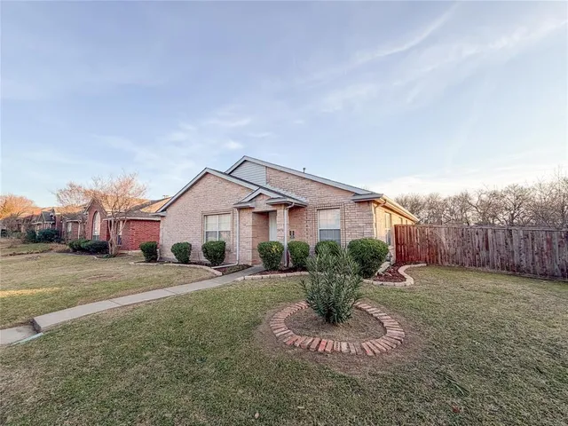 a view of a car parked in the back yard of a house