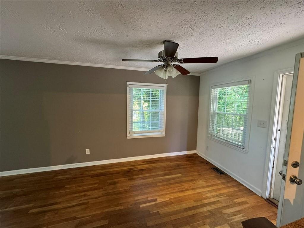 190 Cleveland Street Southeast Atlanta, GA 30316 - Photo 12 of 31 a view of an empty room with wooden floor and a window