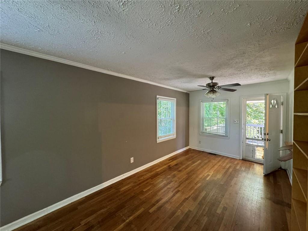 190 Cleveland Street Southeast Atlanta, GA 30316 - Photo 14 of 31 an empty room with wooden floor and windows