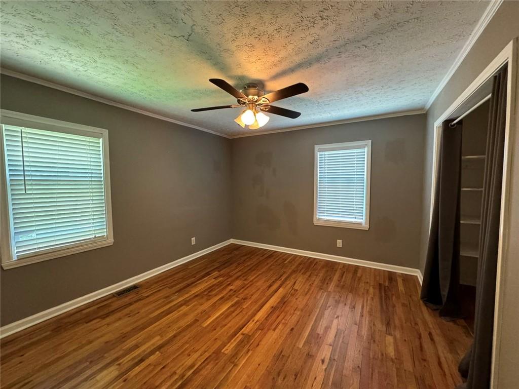 190 Cleveland Street Southeast Atlanta, GA 30316 - Photo 16 of 31 a view of an empty room with wooden floor and a window