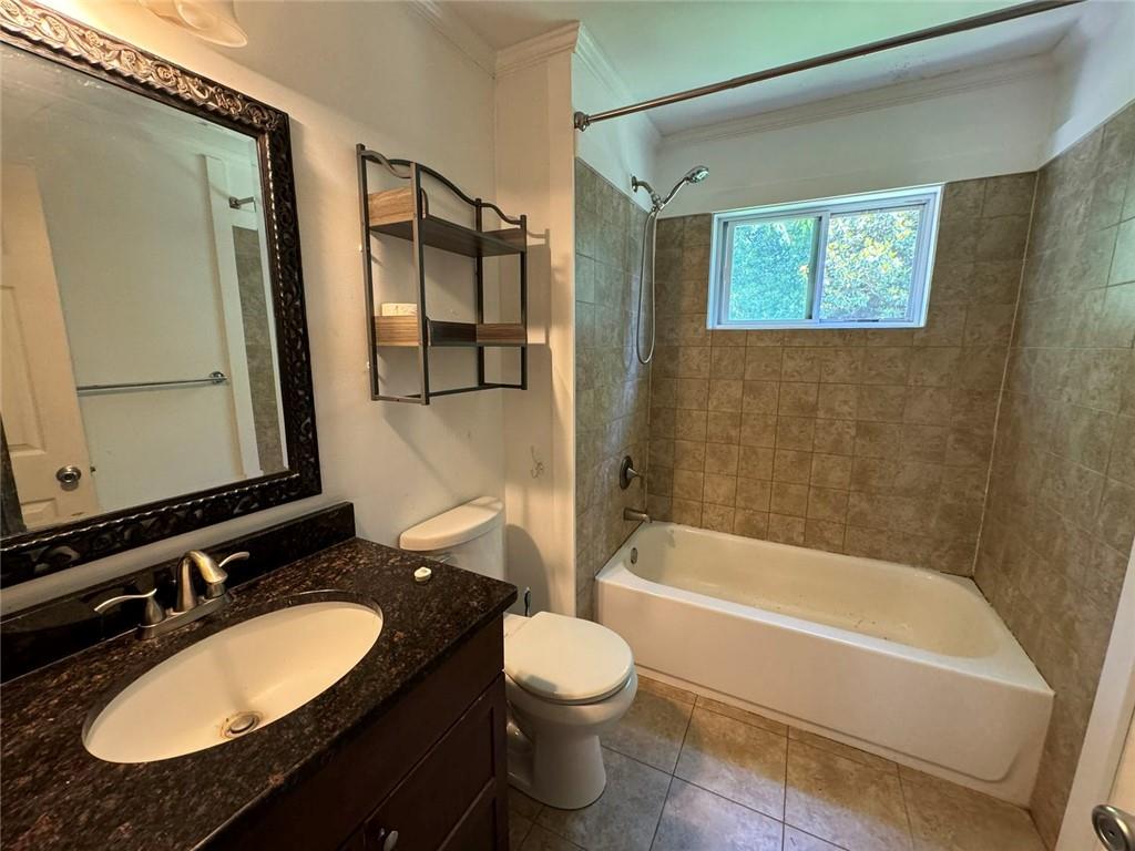 190 Cleveland Street Southeast Atlanta, GA 30316 - Photo 21 of 31 a bathroom with a granite countertop sink toilet a mirror and bathtub