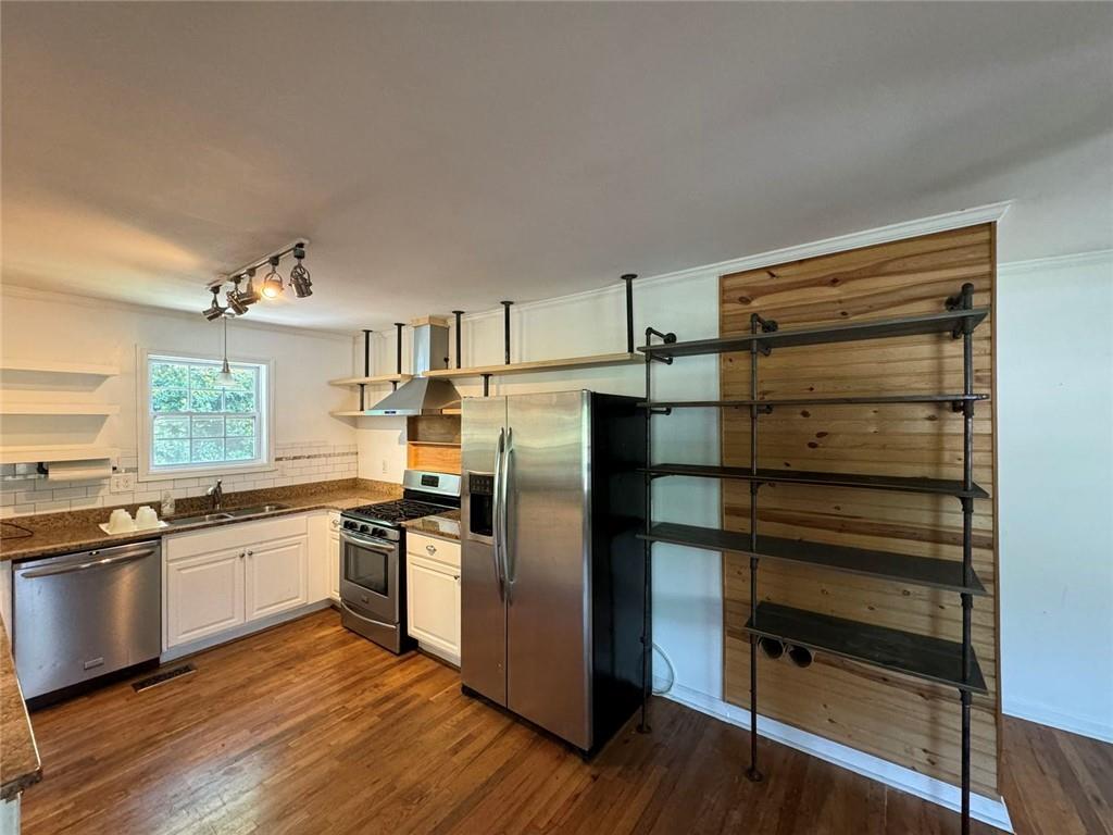 190 Cleveland Street Southeast Atlanta, GA 30316 - Photo 10 of 31 a kitchen with a refrigerator and white cabinets