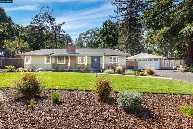 a front view of a house with garden