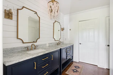 a bathroom with a double vanity sink and a mirror