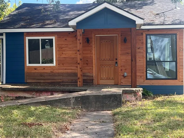 a view of a house with a small yard