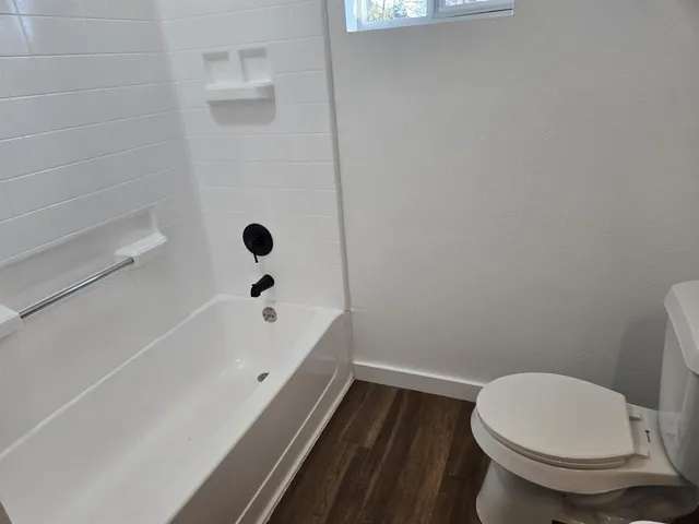 a bathroom with a toilet and a bathtub