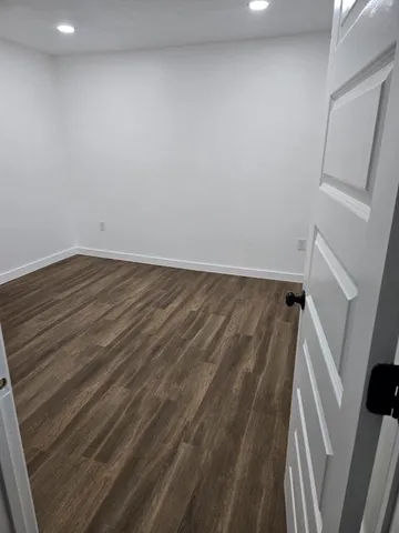 a view of wooden floor in an empty room