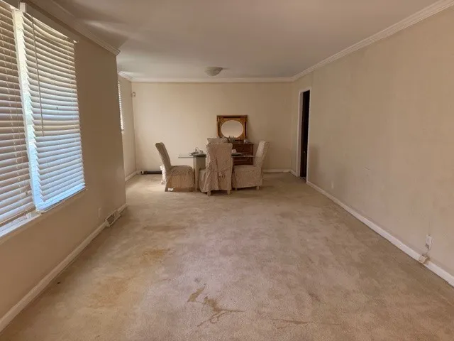 a kitchen with a sink stainless steel appliances and window