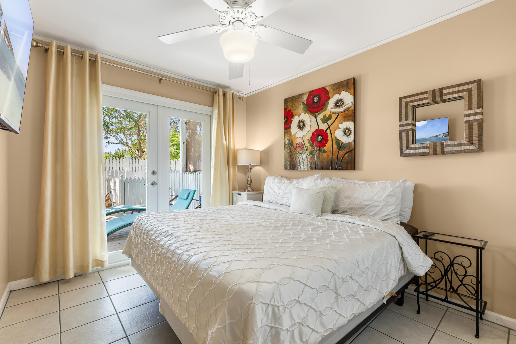 620 Thomas Street, Unit 175 Key West, FL 33040 - Photo 15 of 30 a bedroom with a large bed and a chandelier