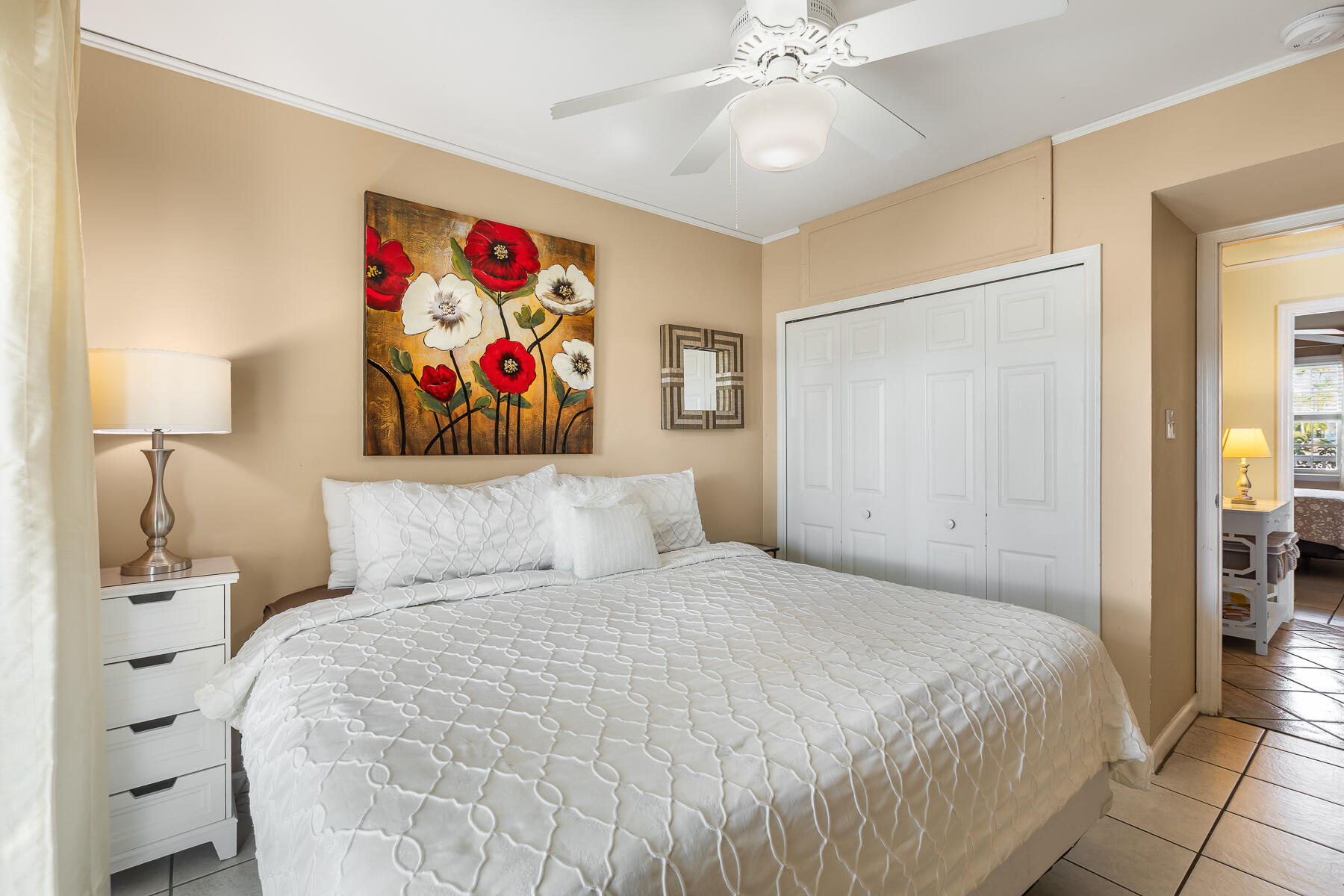 620 Thomas Street, Unit 175 Key West, FL 33040 - Photo 25 of 30 a bedroom with a large bed and a chandelier