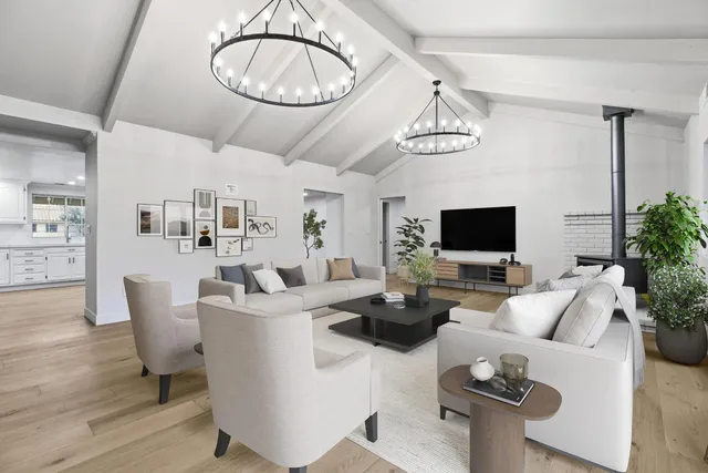 a kitchen with white cabinets and window
