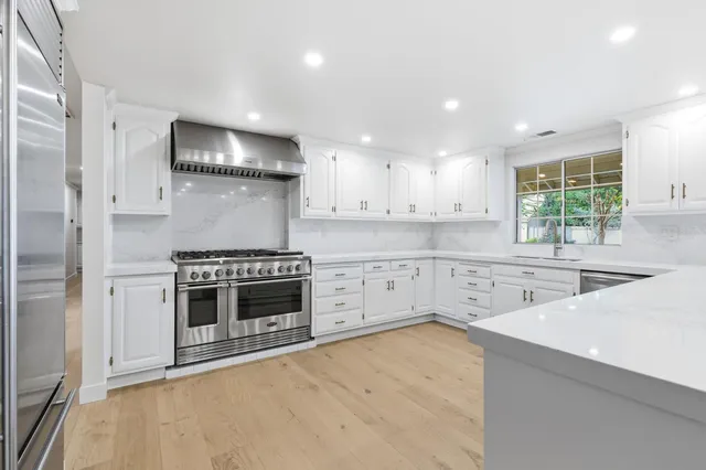 a bathroom with a double vanity sink mirror and toilet