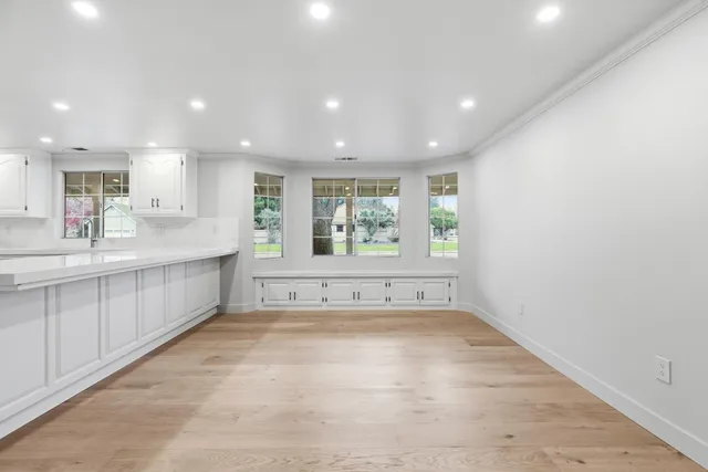 a spacious bedroom with a large bed and a chandelier