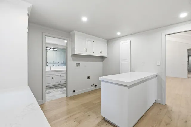 an empty room with windows and ceiling fan