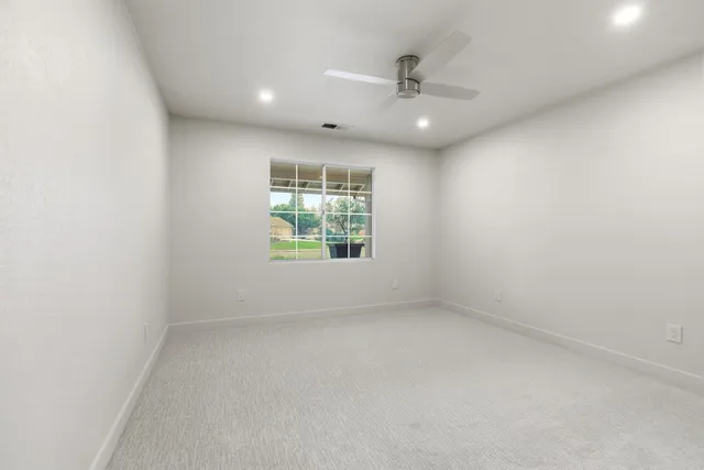 a bathroom with a granite countertop sink mirror and toilet