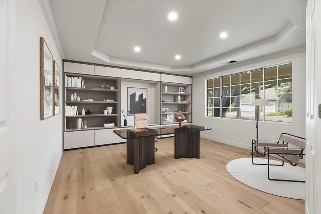 a living room with furniture a flat screen tv and a chandelier