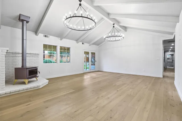 a large kitchen with cabinets and wooden floor