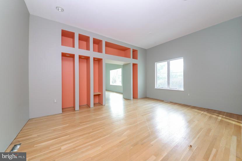 6613 Persimmon Tree Road Cabin John, MD 20818 - Photo 11 of 23 a view of an empty room with wooden floor and a window