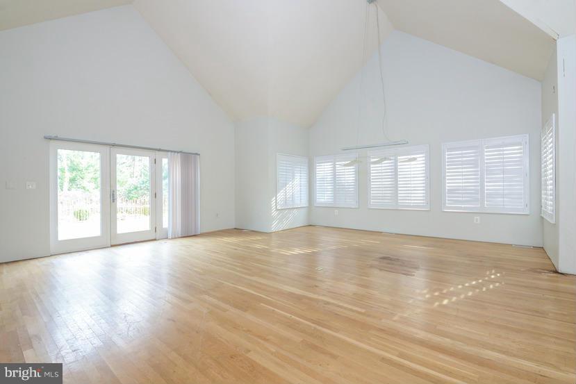 6613 Persimmon Tree Road Cabin John, MD 20818 - Photo 16 of 23 a view of an empty room with wooden floor and a window
