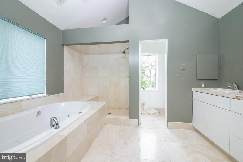 6613 Persimmon Tree Road Cabin John, MD 20818 - Photo 20 of 23 a bathroom with a bathtub and a sink