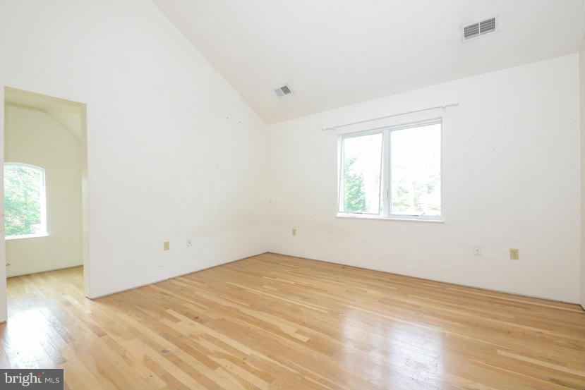 6613 Persimmon Tree Road Cabin John, MD 20818 - Photo 3 of 23 an empty room with wooden floor and windows