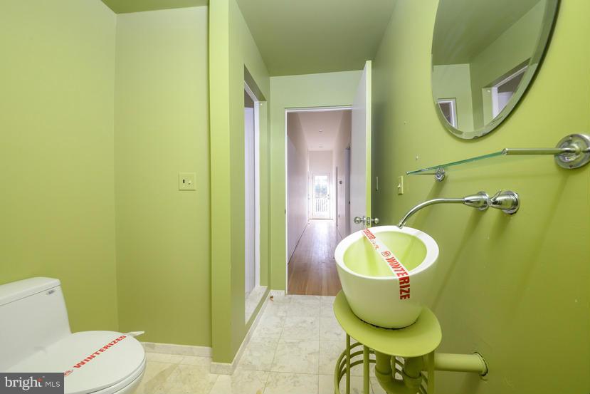 6613 Persimmon Tree Road Cabin John, MD 20818 - Photo 21 of 23 a bathroom with a toilet and a mirror