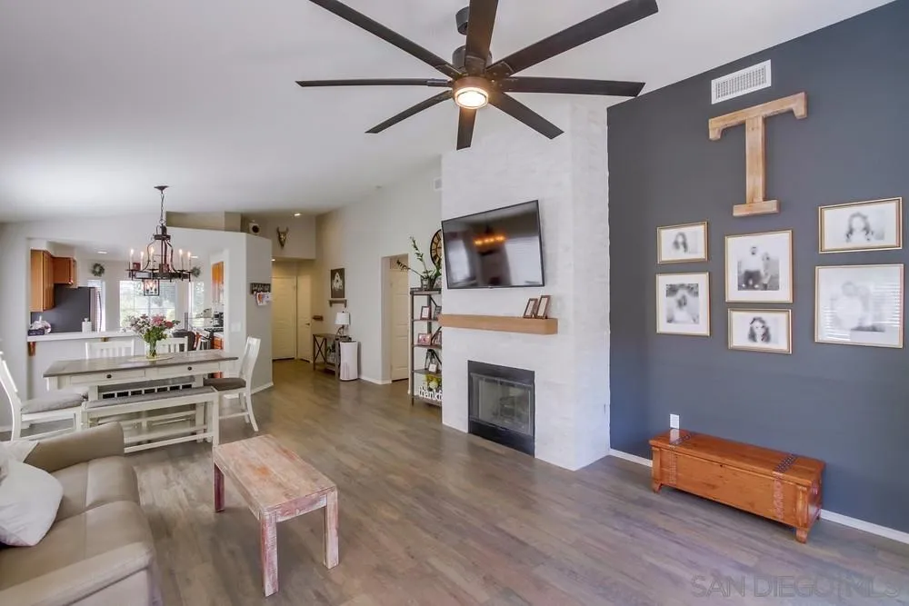 a living room with furniture fireplace and flat screen tv