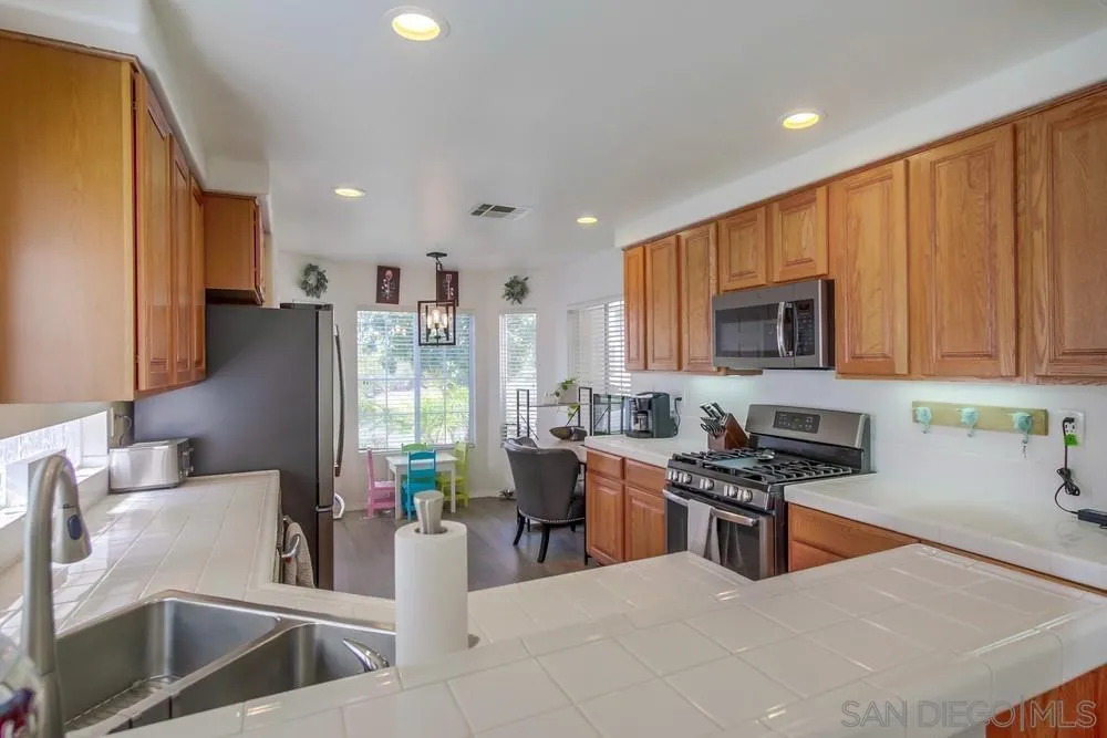 1966 Verbena Terrace Alpine, CA 91901 - Photo 13 of 41 a kitchen with stainless steel appliances granite countertop a refrigerator stove and sink