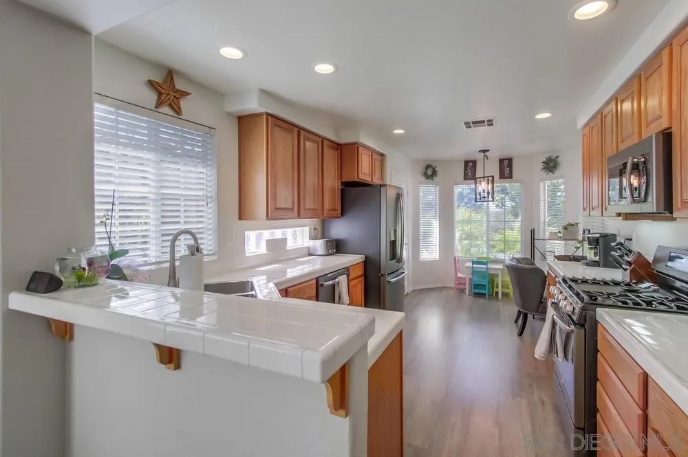 1966 Verbena Terrace Alpine, CA 91901 - Photo 14 of 41 a kitchen with stainless steel appliances granite countertop a sink stove and refrigerator